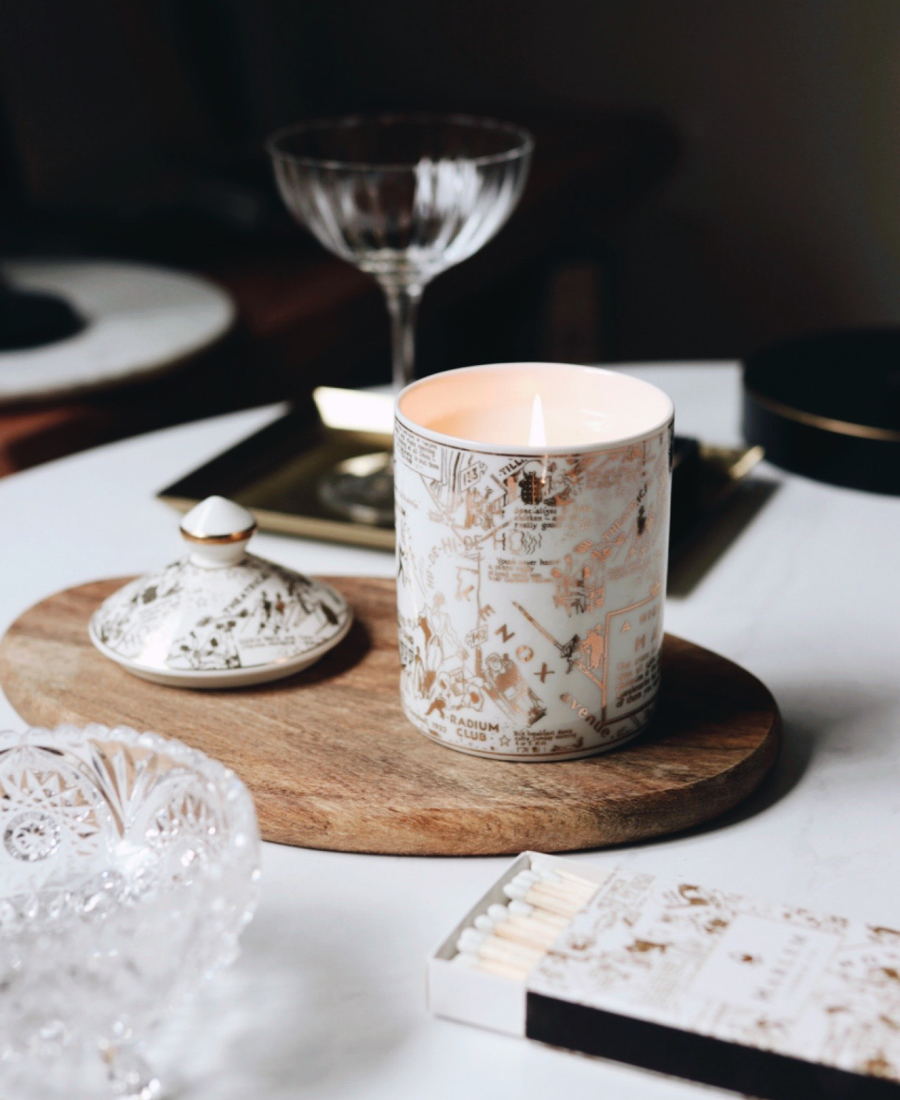 Speakeasy Ceramic Candle on a wooden tray with the candle lid, matches, and glassware.