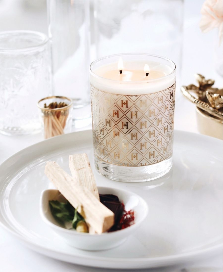 22k Gold Speakeasy Candle on a white tray with aromatic items.