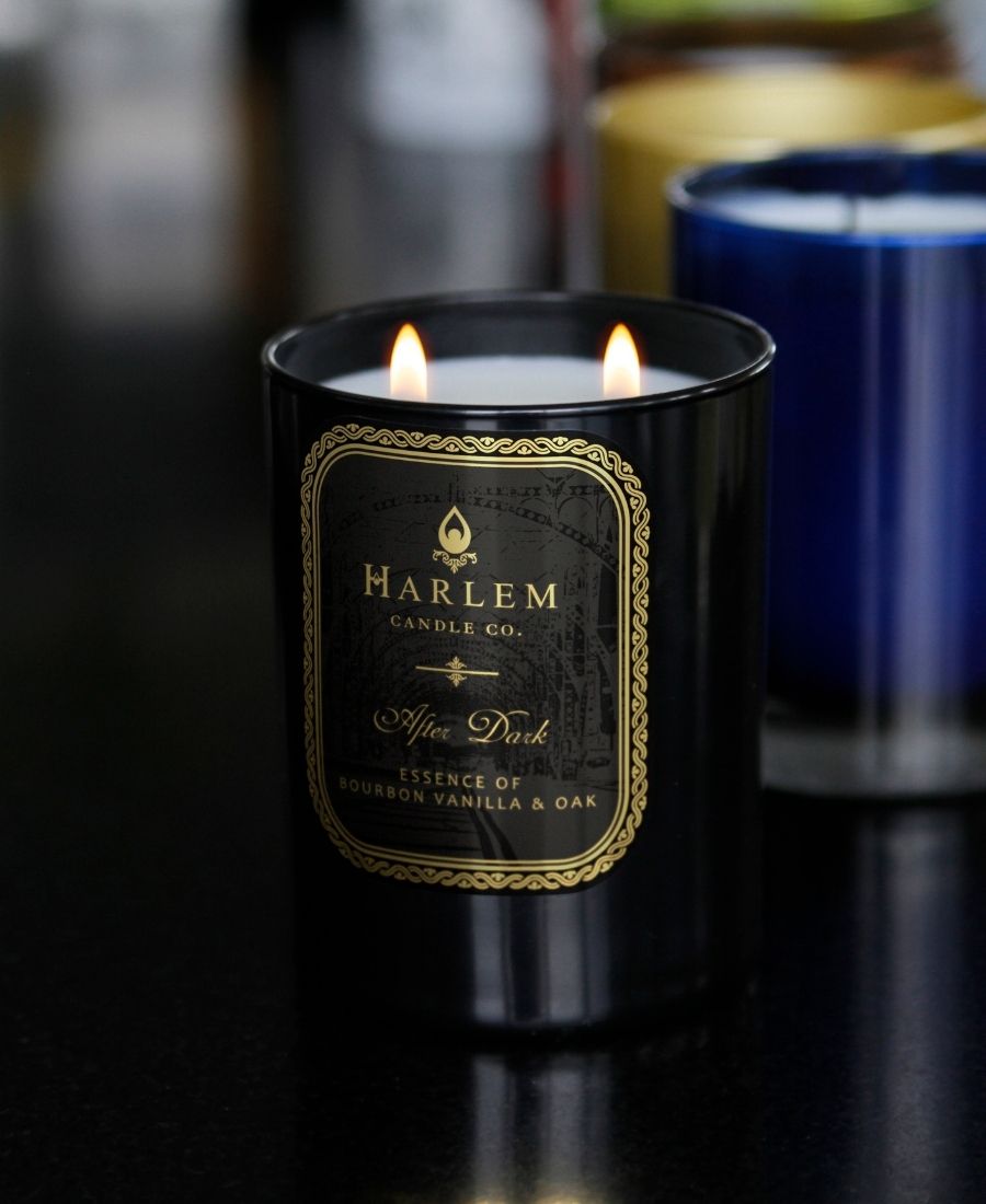 After Dark Candle on a black table with other candles.