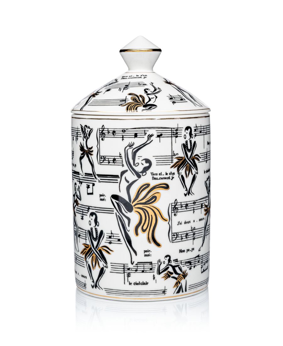 This is an image of our gold and white Deux Amours, ceramic candle with a lid. It features illustrations of Josephine Baker, and other original illustrations.