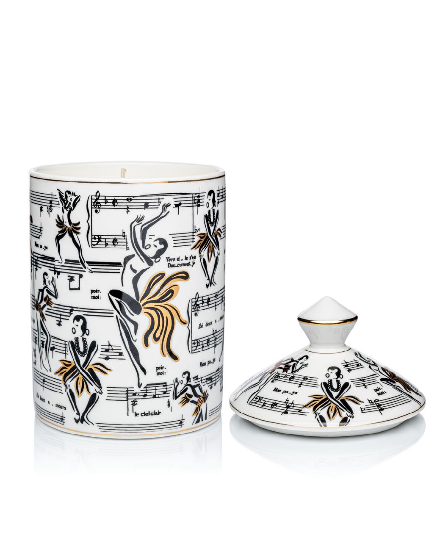 This is an image of our gold and white Deux Amours, ceramic candle with a lid. It features illustrations of Josephine Baker, and other original illustrations.
