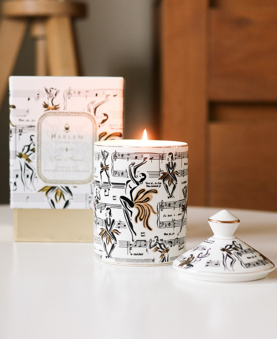 Deux Amours Ceramic Candle on a white table next to the lid and box.