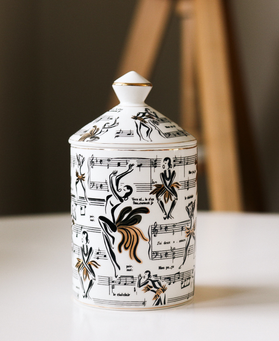Deux Amours Ceramic Candle on a white table topped with the candle lid.