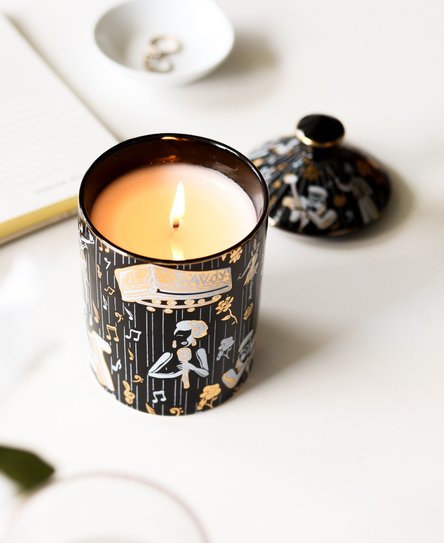 Duke Ceramic Candle on a white table next to the lid, jewelry, and a journal.