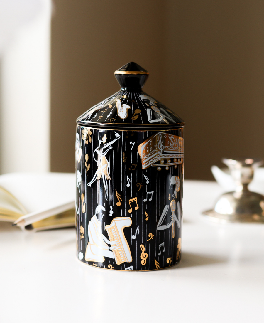 Duke Ceramic Candle on a white table next to a journal and topped with the candle lid..