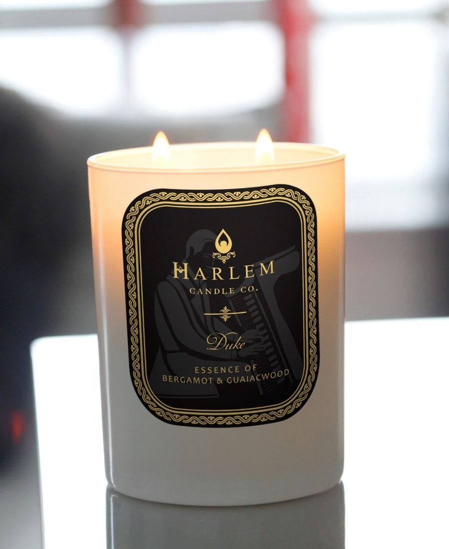 Duke candle on a reflective table.