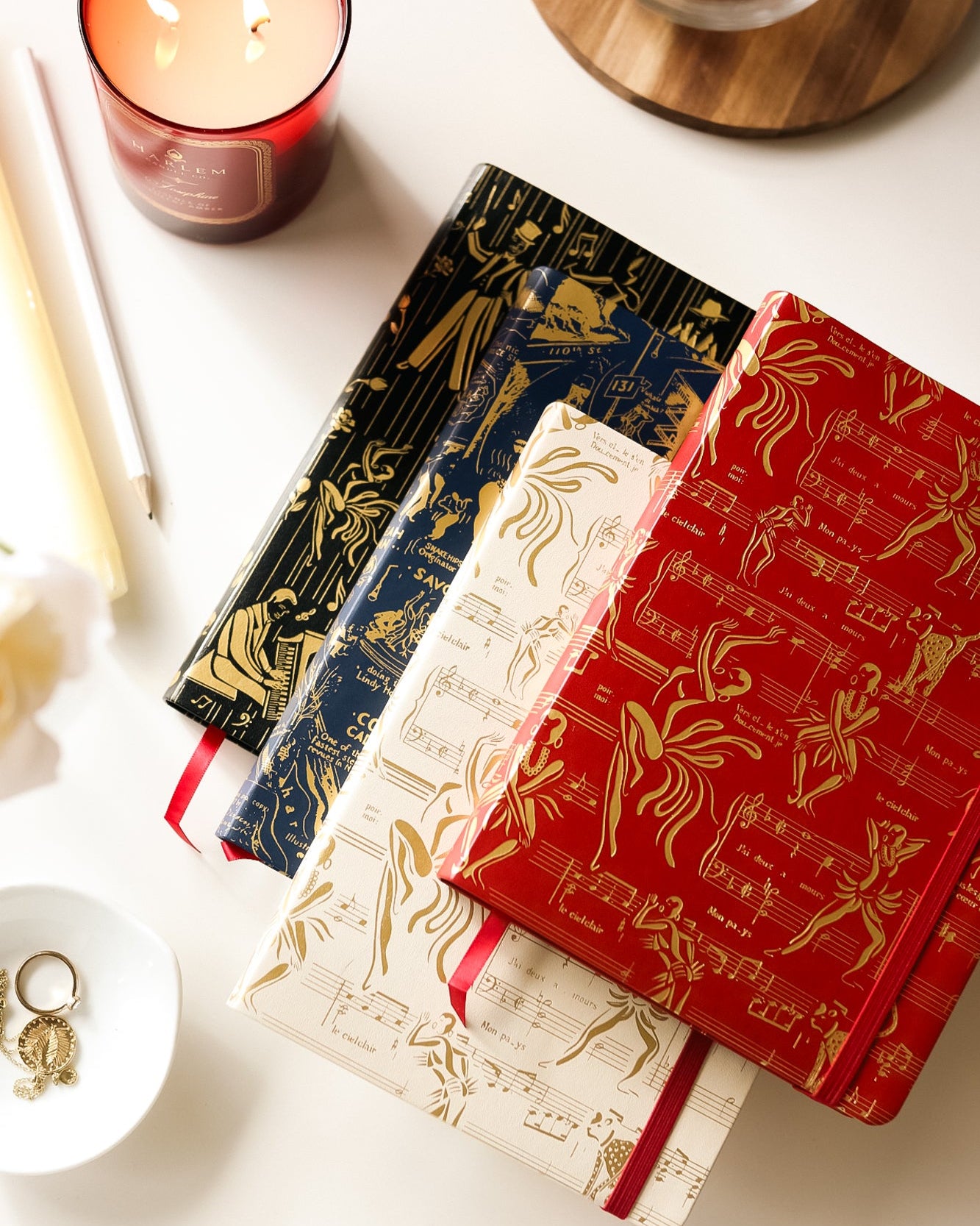Image of four journals - black, blue, cream and red.