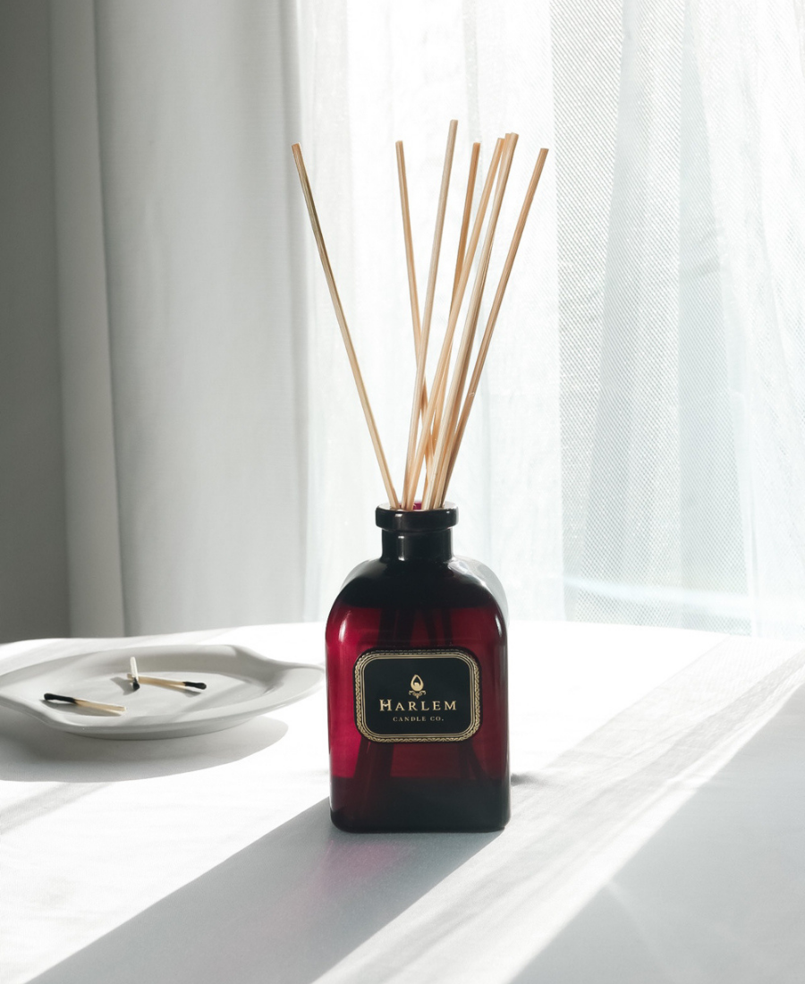 Josephine Reed Diffuser on a white table with burnt matches.