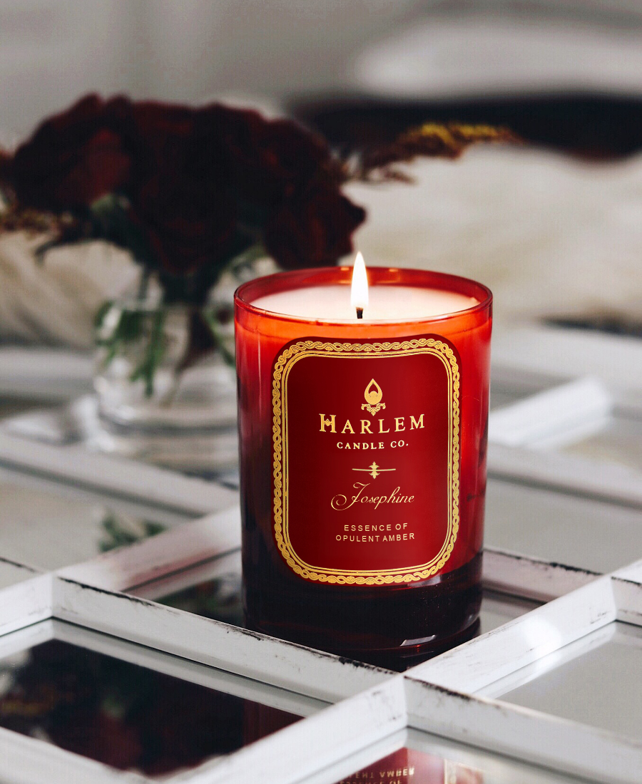 Josephine 1 Wick Candle on a reflective table with flowers.