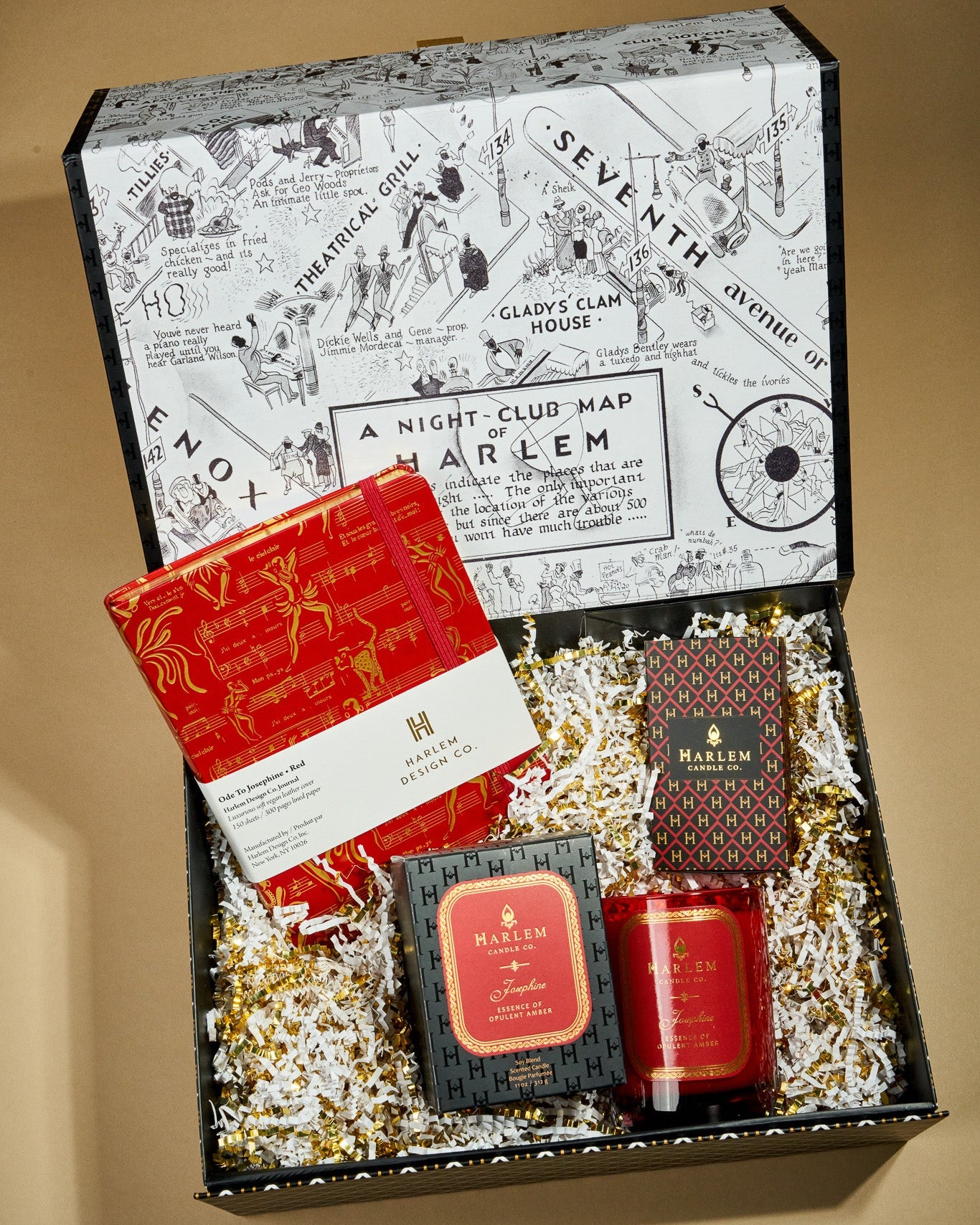This is an image of our Josephine secrets gift box which include our 11 ounce Josephine candle, or red and gold, Josephine Journal, and our red and gold, gold art, deco, elegant matches.