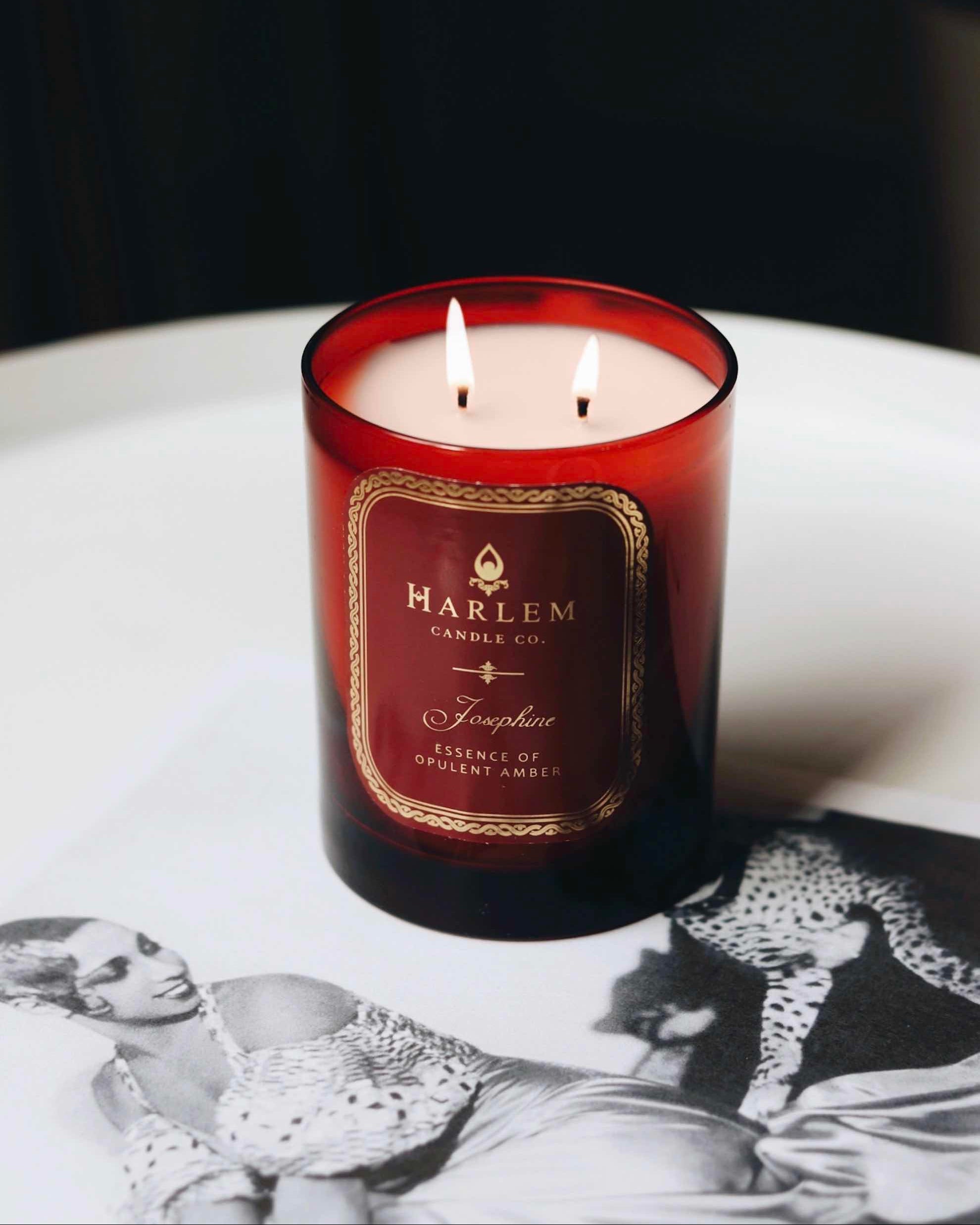 Josephine candle lifestyle image sitting next to an image of Josephine baker and her pet cheetah