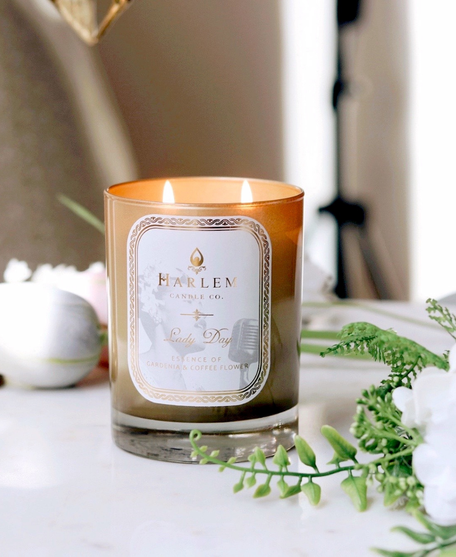 Lady Day Candle on a white table with flowers