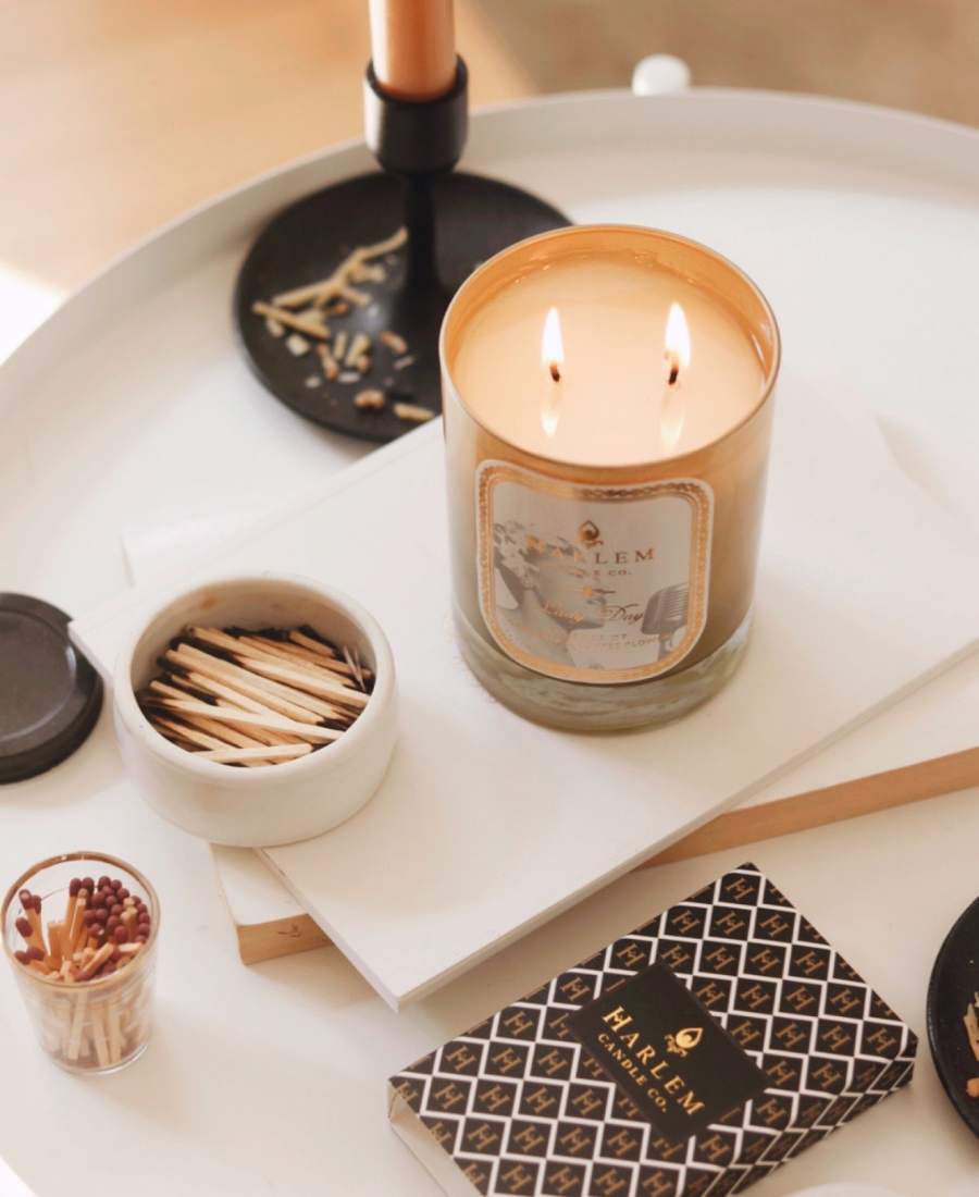 Lady Day Candle on a white table with matches and candles.