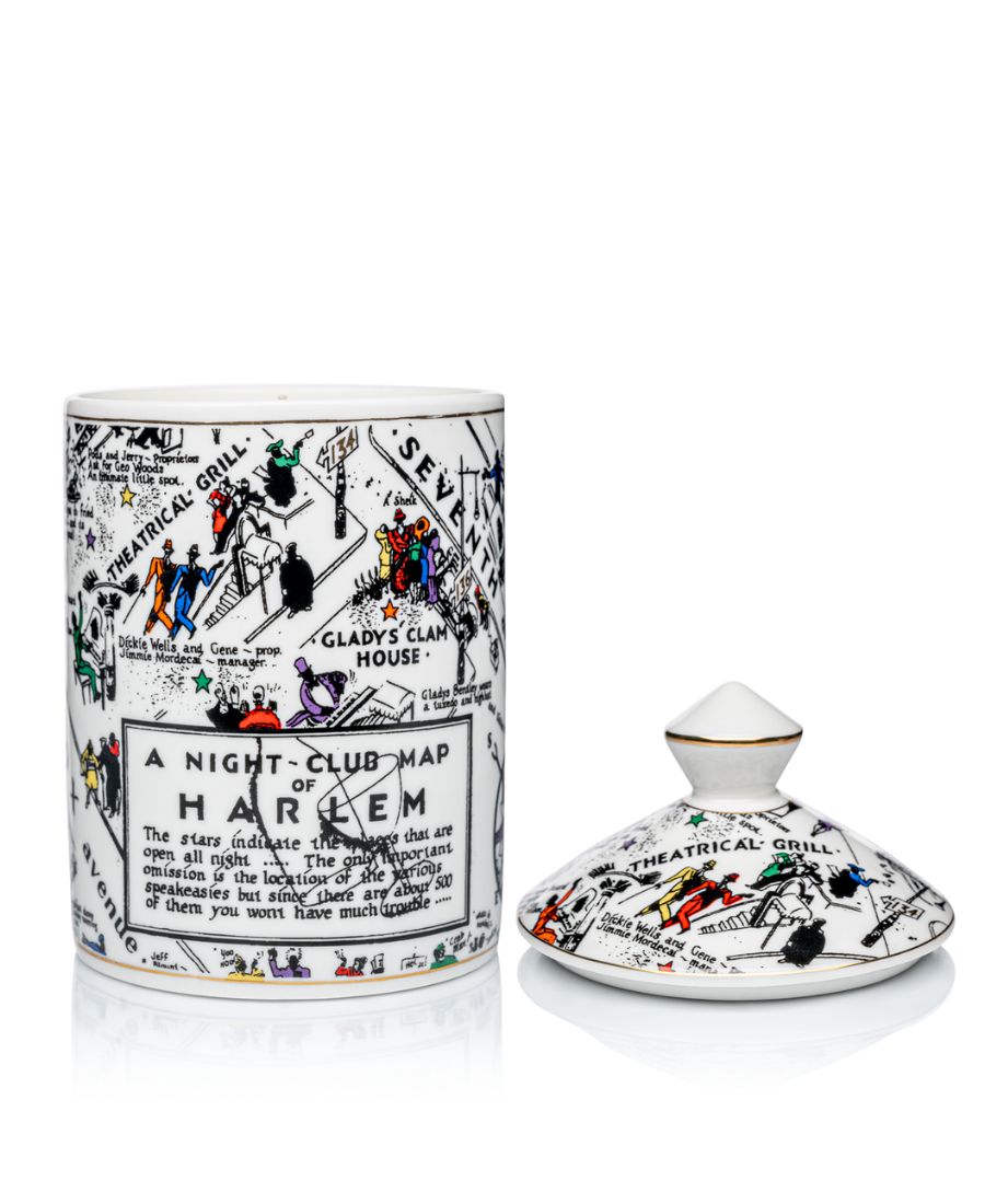 This is an image of our night club map of Harlem candle in black-and-white with pops of color. This candle has a dome lid and is Fragrance with the Langston scent. In this image, the lid is positioned next to the candle versus on top
