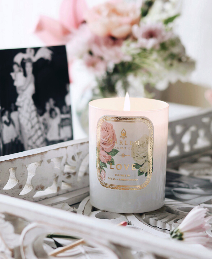 Love Candle in a white decorative tray with a vintage photograph and flowers.