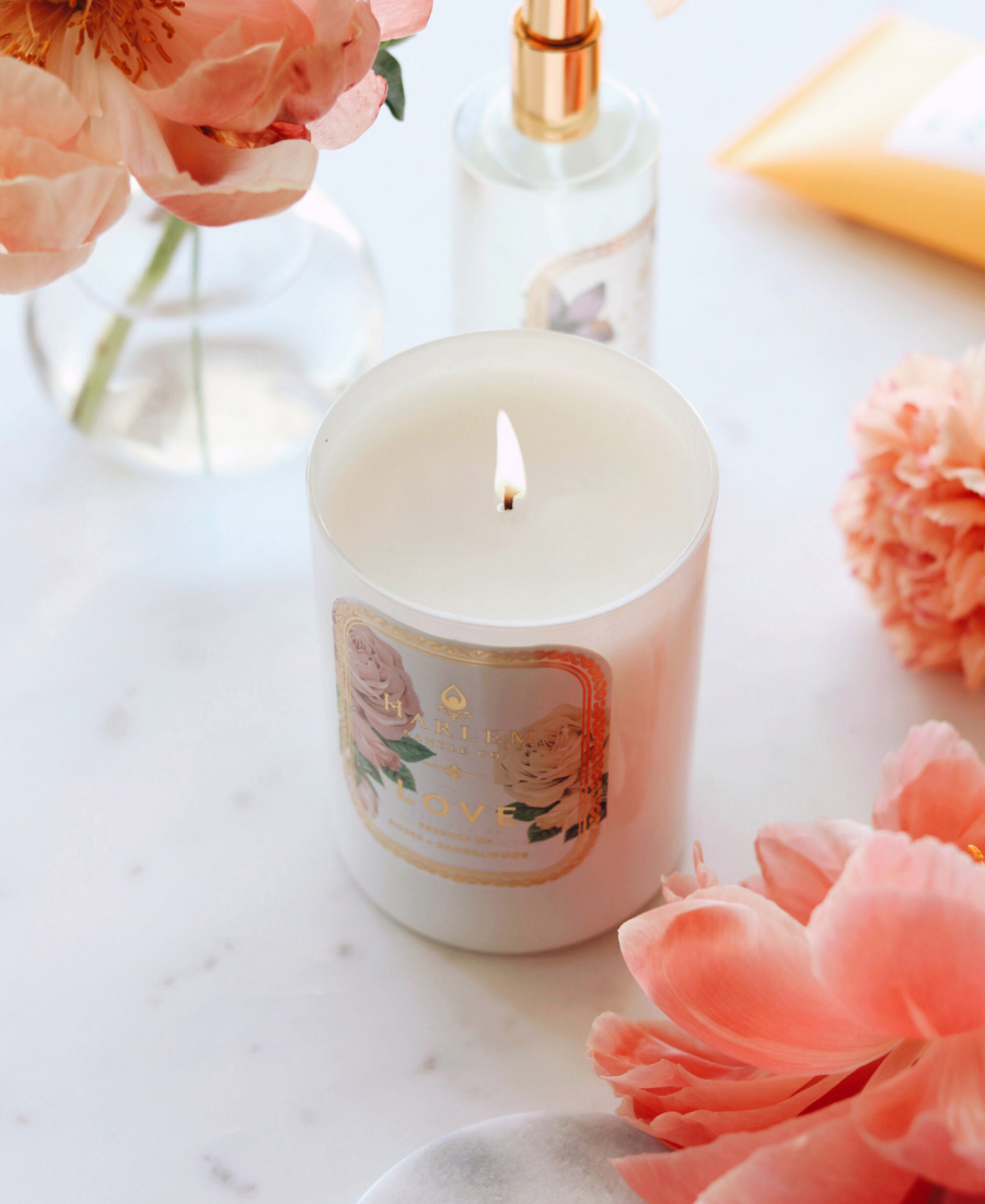 Love Candle in a white table flowers and the Love Room and Linen Spray.