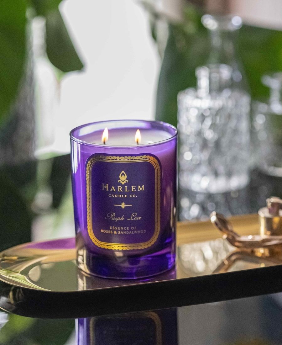 Purple Love Candle on a gold tray with glassware.