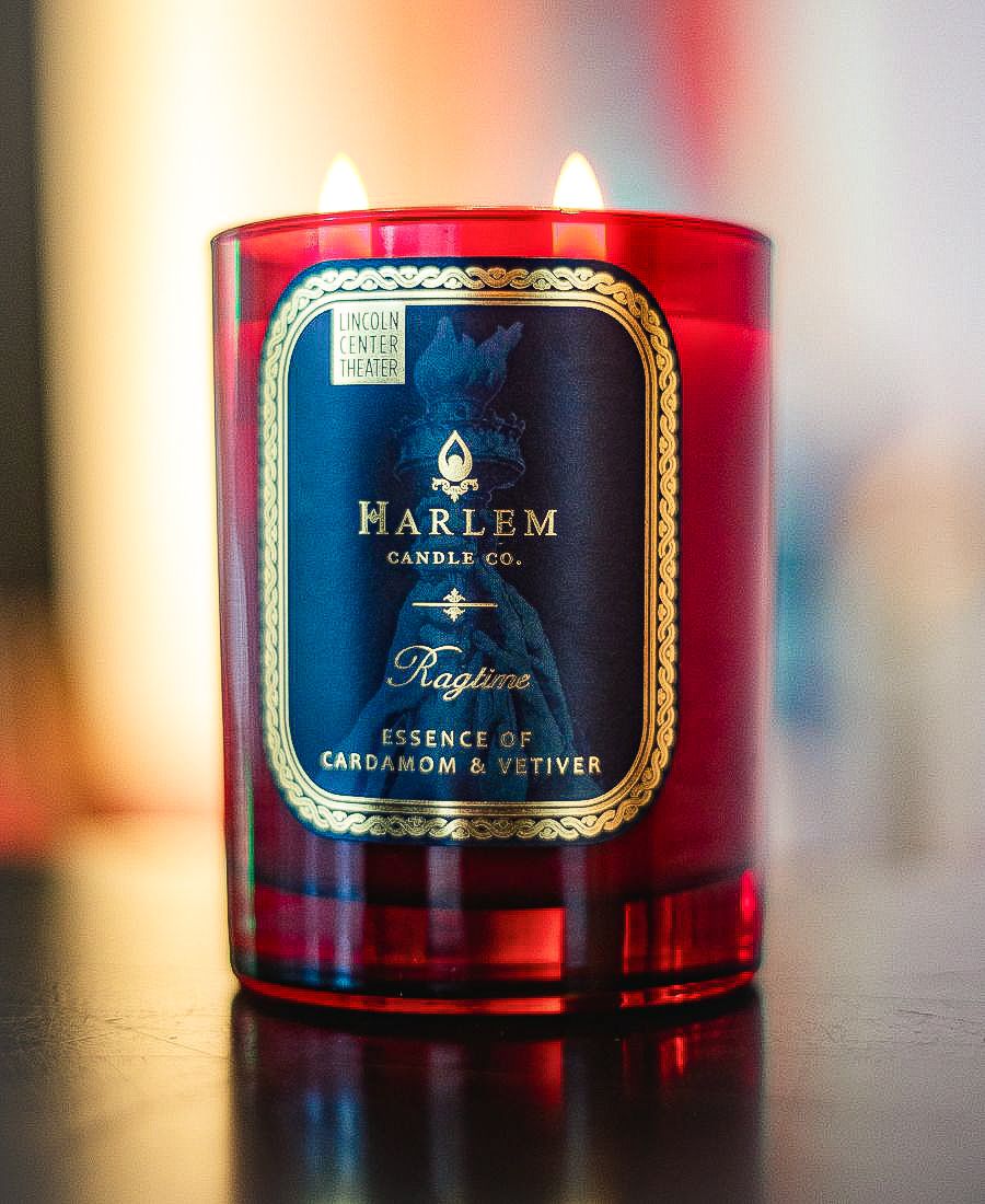 Harlem Candle Co. candle with a blue label on a blurred background