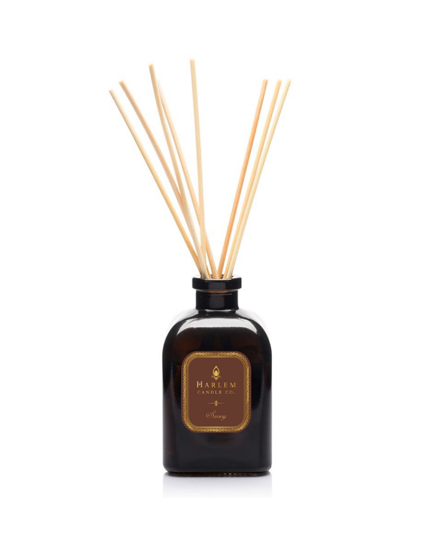 Savoy reed diffuser bottle filled with multiple natural wood reed sticks rising above the top, set against a plain white background.