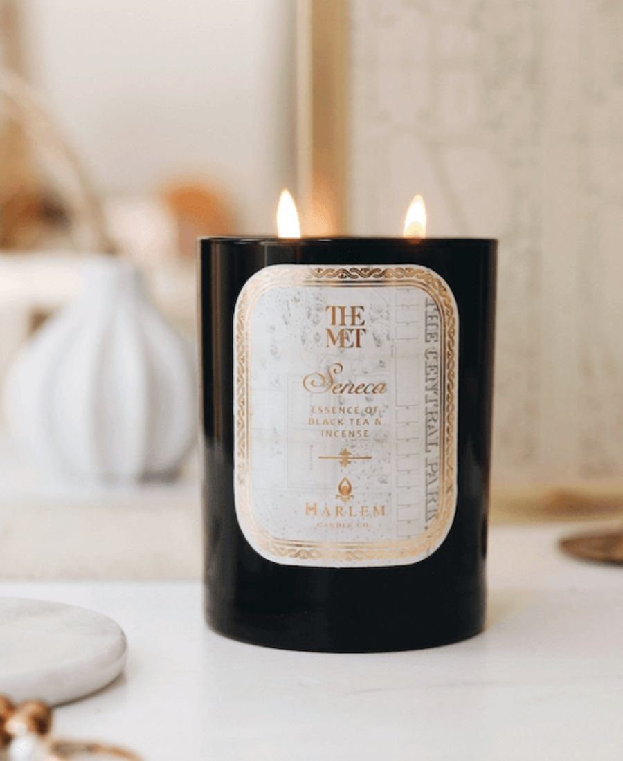 The Met Seneca Candle on a white table.