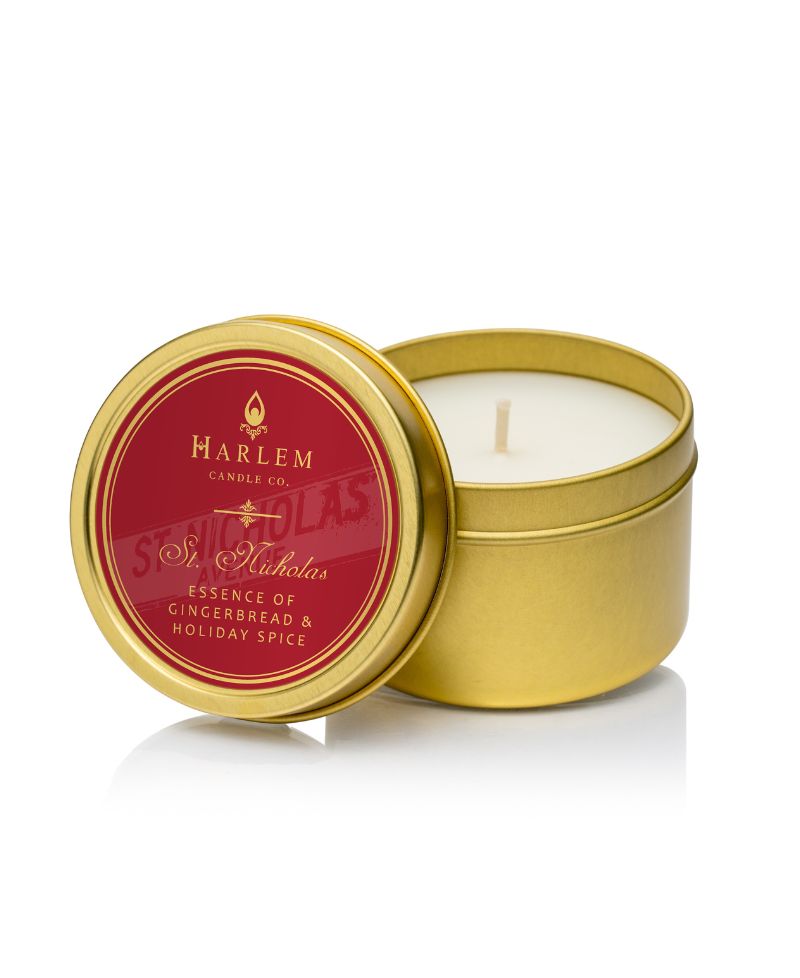 Picture of the St Nicholas Travel candle. It is in a gold tin with a red label on the top.