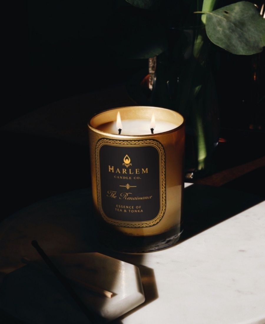 The renaissance candle glowing in shadows on a white table.