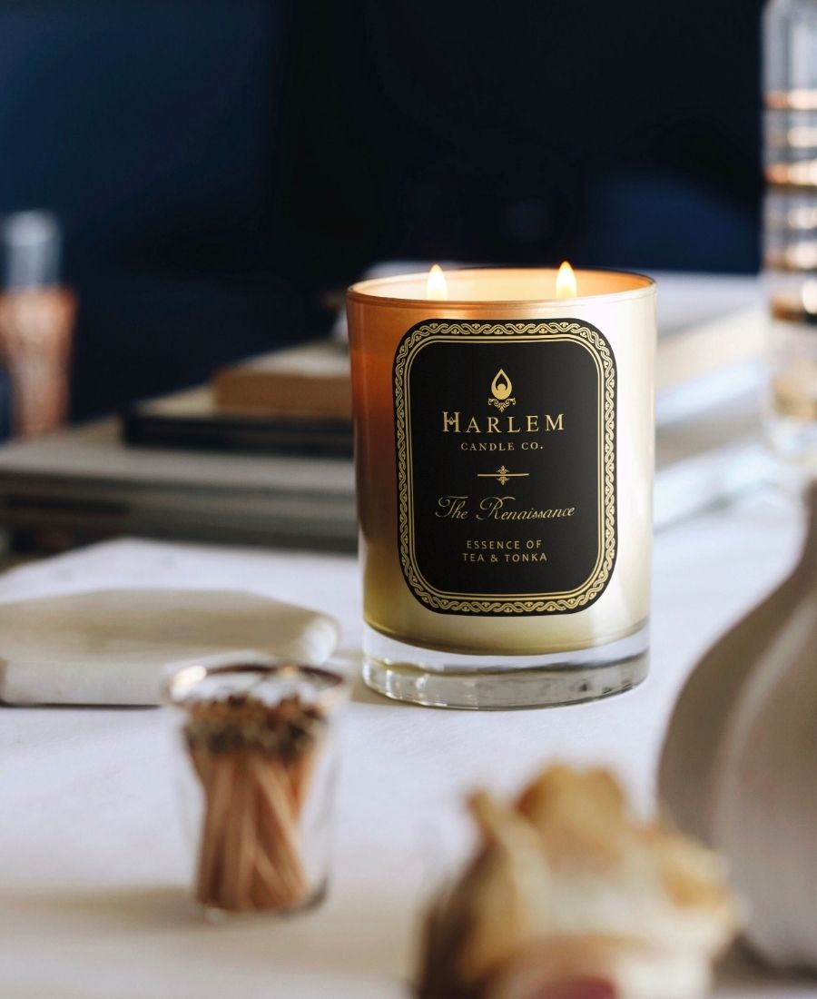 The Renaissance Candle on a white desk.