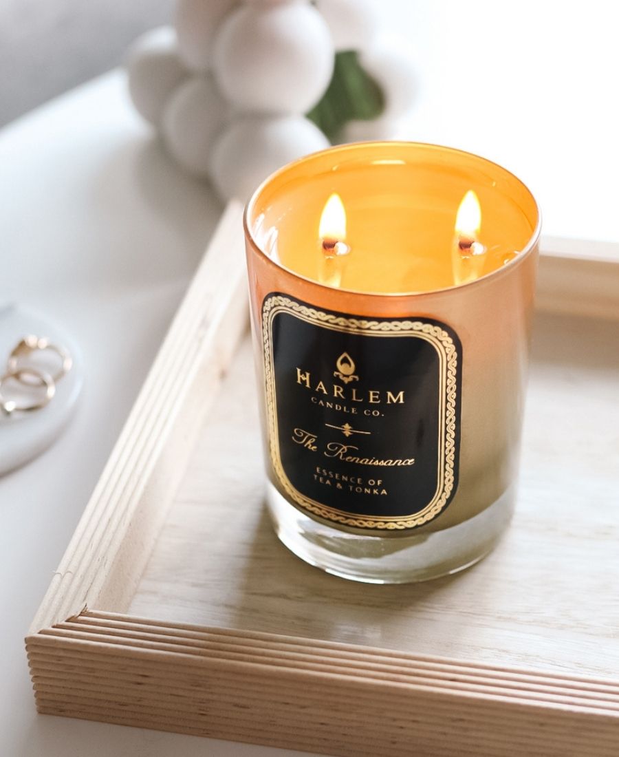 The Renaissance candle on a wooden tray.