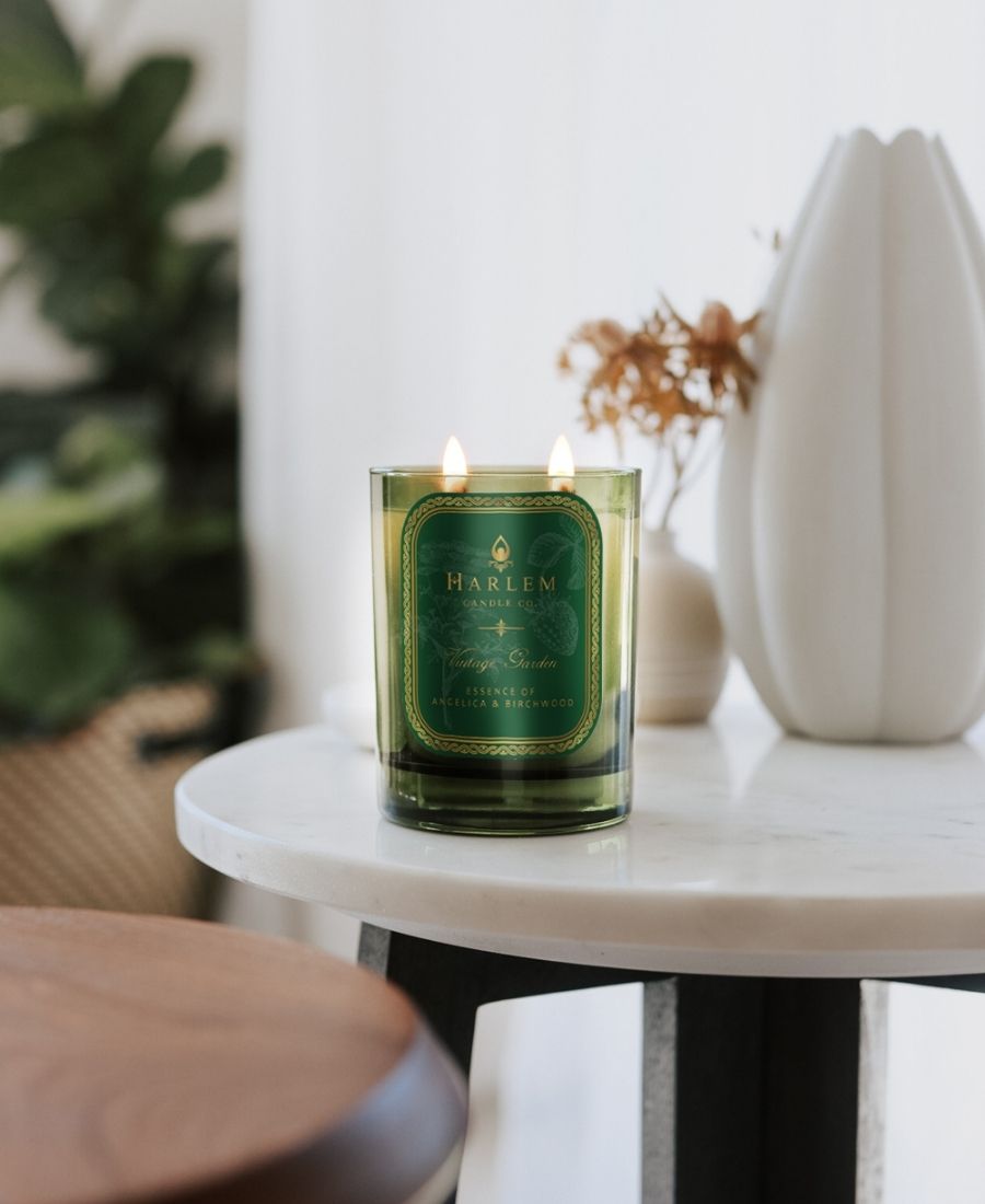 Vintage Garden Candle on a white marble table with flower vases.