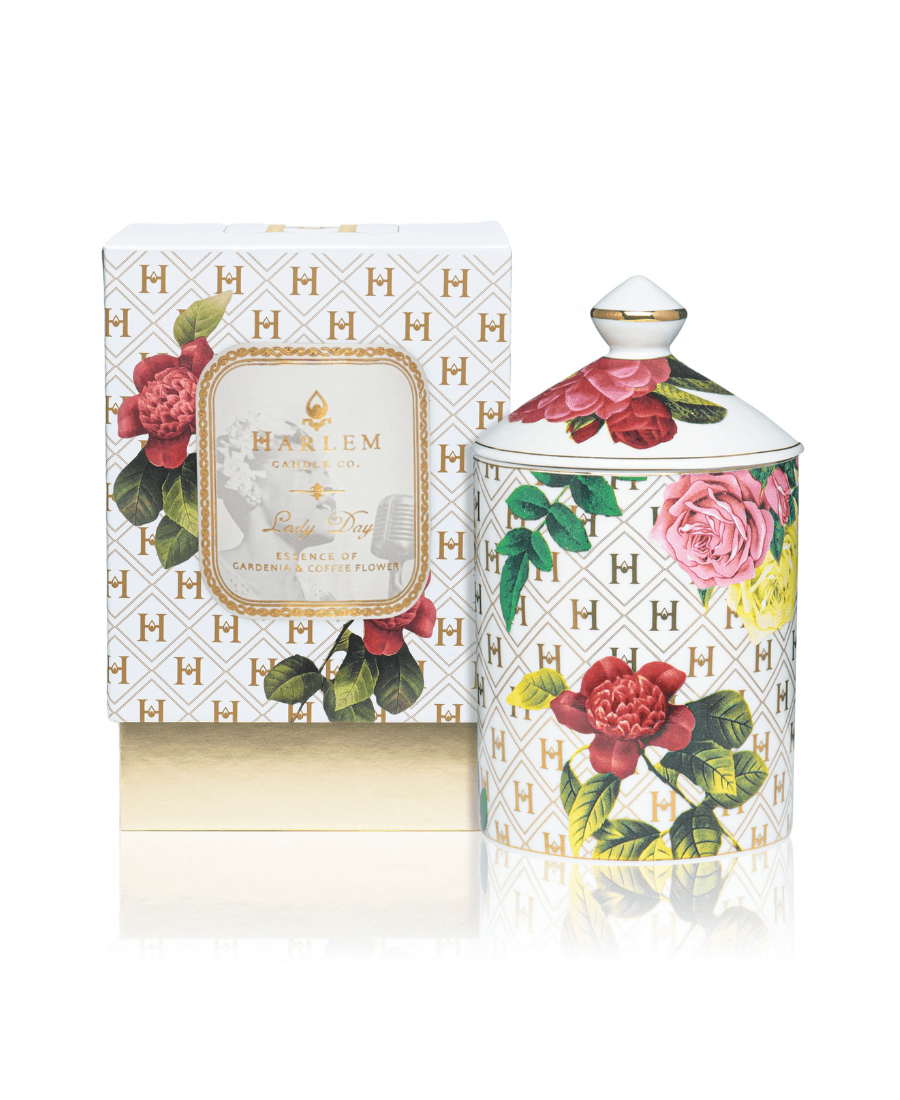 Our “Lady Day” White Floral Ceramic Luxury Candle with lid sitting next to its gorgeous decorative box.