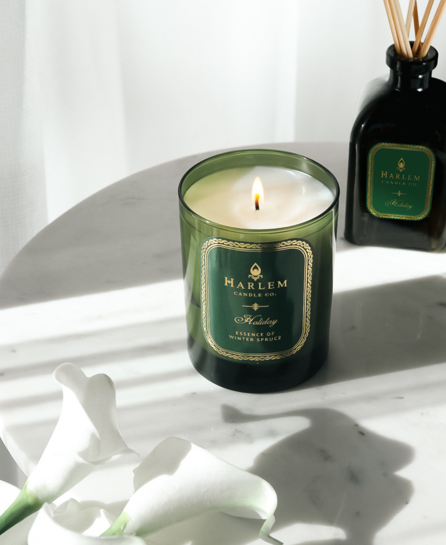 Holiday Candle on a white table with the Holiday diffuser
