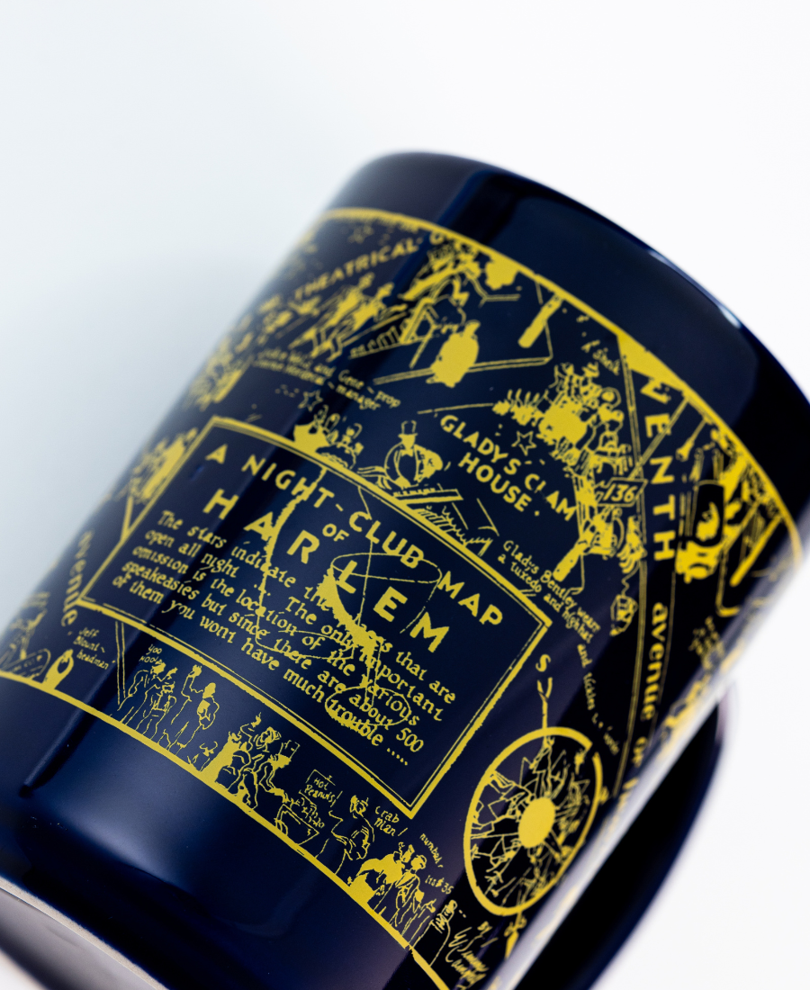 Navy blue cylindrical container with gold decorative map design on a white background