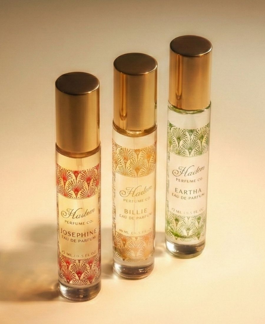 Three perfume bottles with gold caps on a beige background