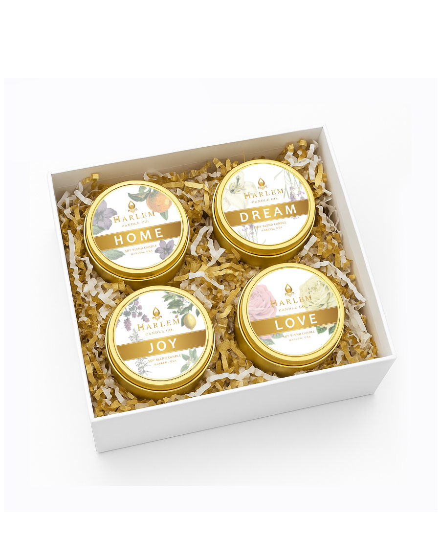 Four gold tins with labels 'Home', 'Dream', 'Joy', and 'Love' in a decorative box.