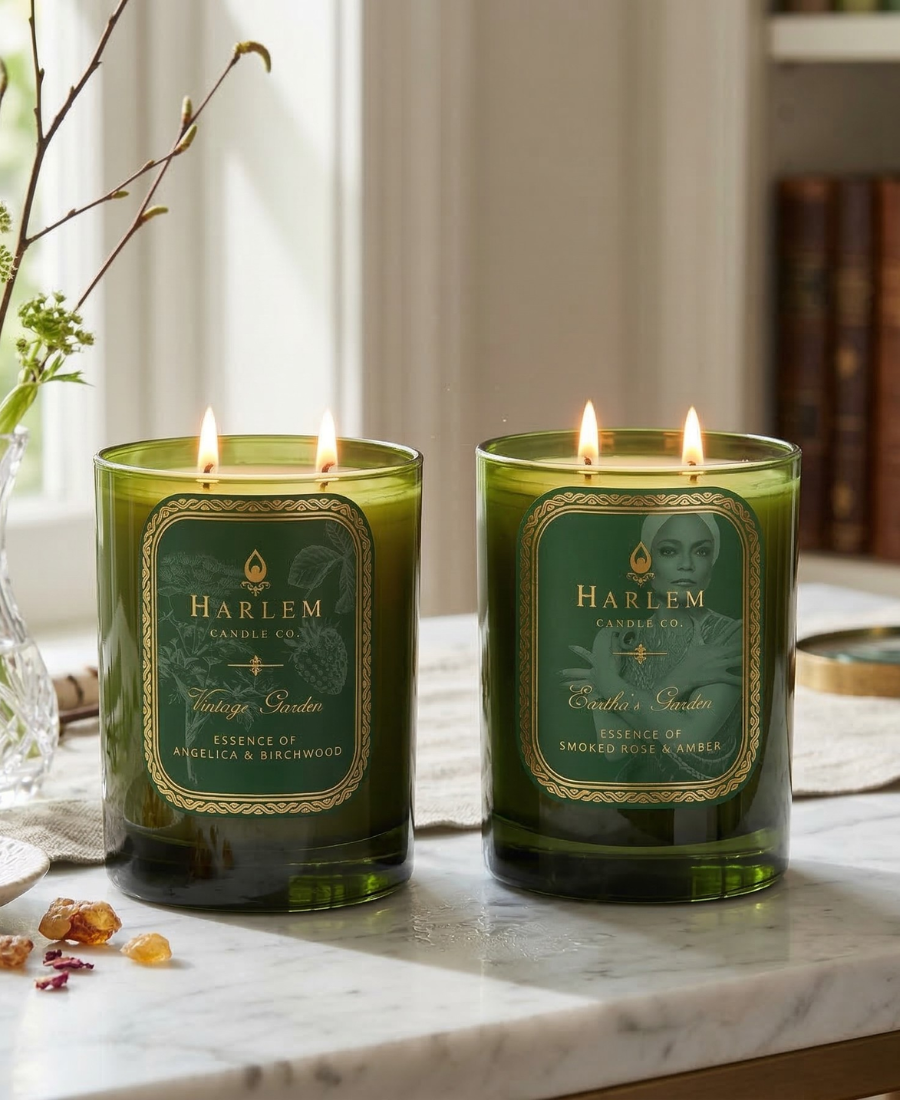 Two green candles with labels on a marble surface