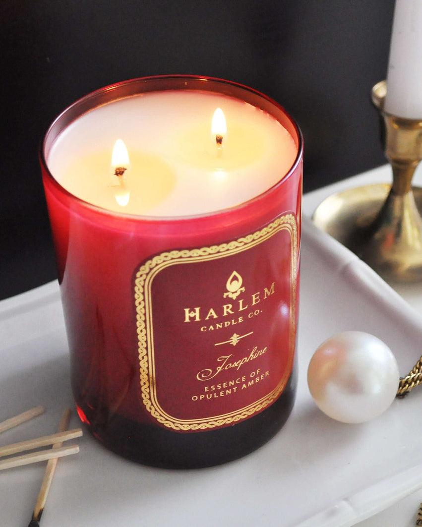 This is an image of our Josephine candle, with two weeks eliminated next to a gold pearl necklace and some used matches.