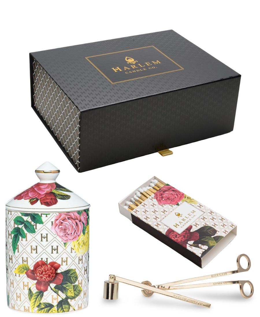 Harlem Candle Co. candle set with decorative box, matches, and wick trimmer on a white background