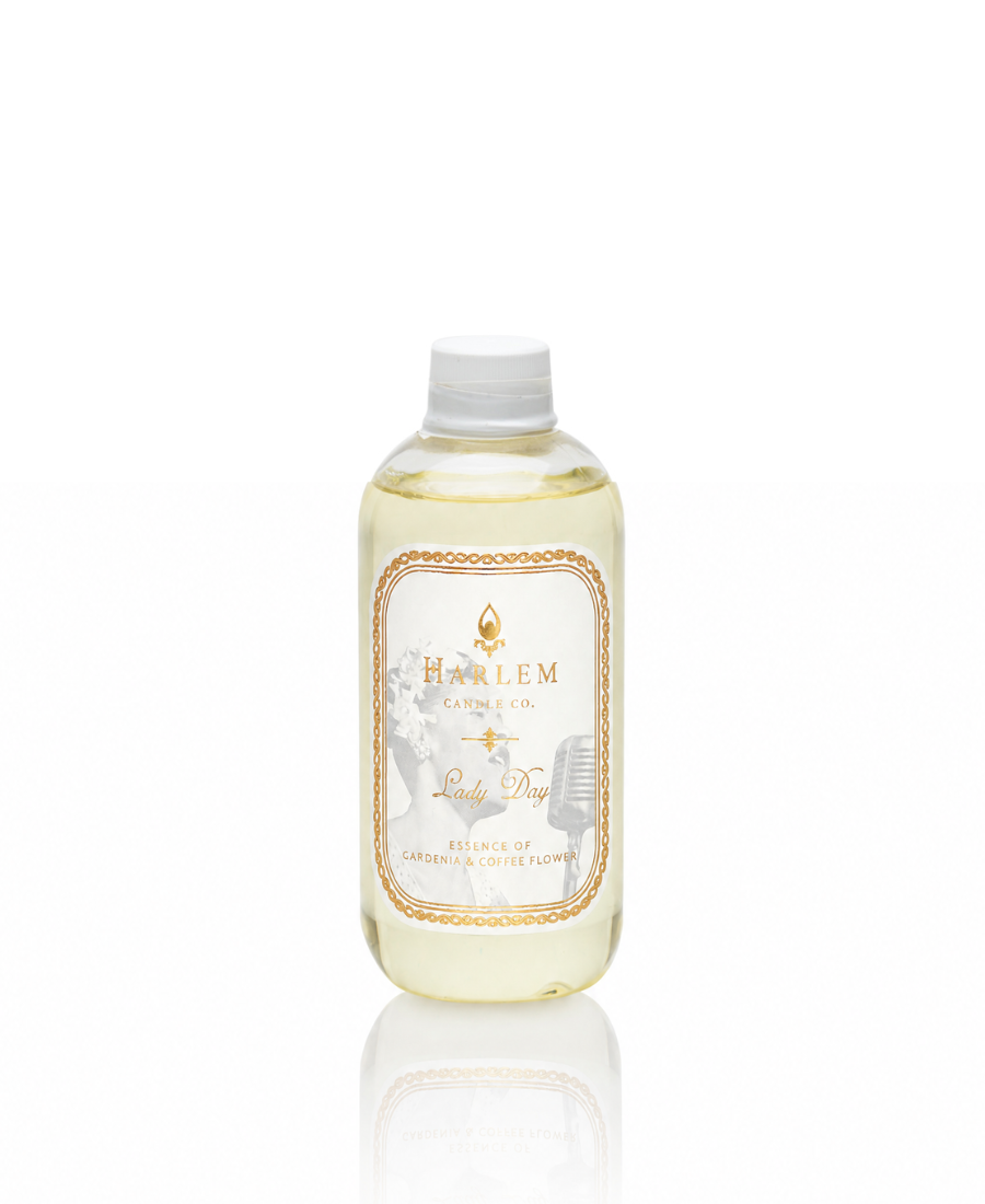 Image of Lady Day reed diffuser refill.  Clear bottle with white and gold label.