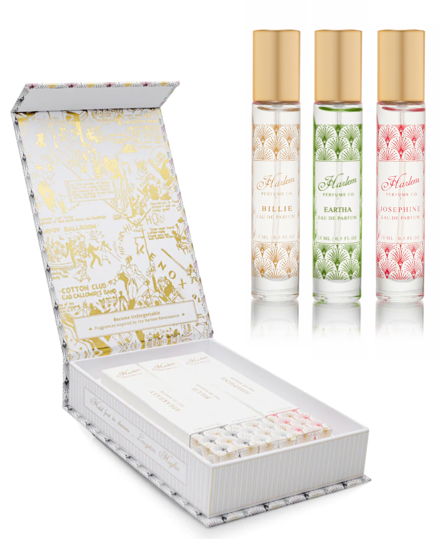 Set of three perfume bottles with gold caps and a decorative box on a white background