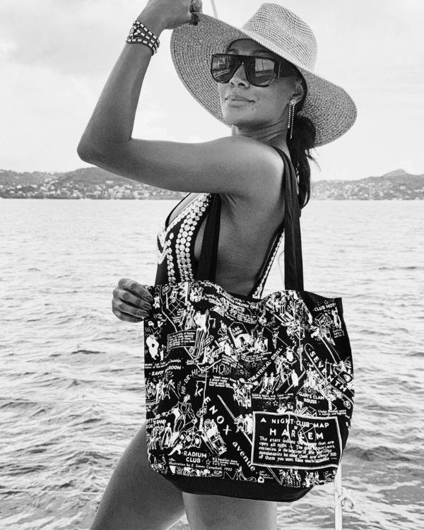 Model with black and white canvas tote on a boat.