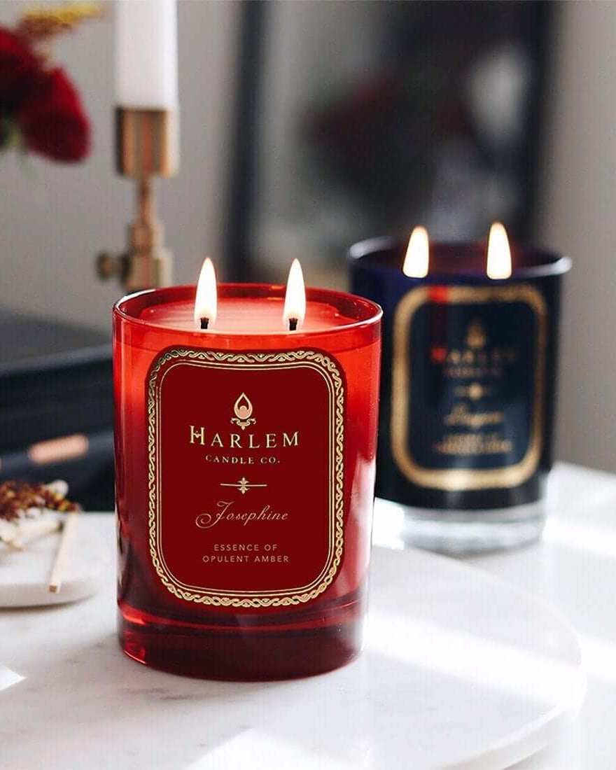 Lifestyle image of the Josephine candle, Langston candle and 22k Gold Savoy nightclub map candle all illuminated.