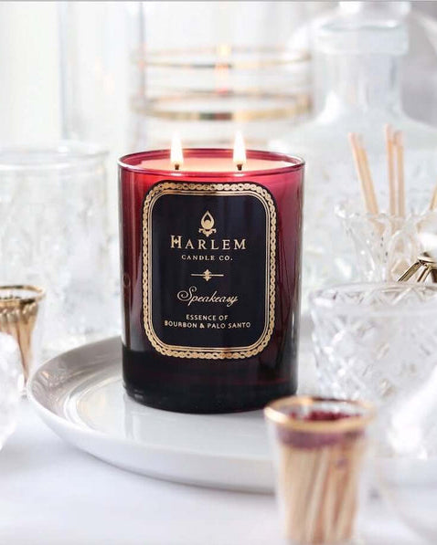 Image of the burgundy Speakeasy candle with the two flames illuminated