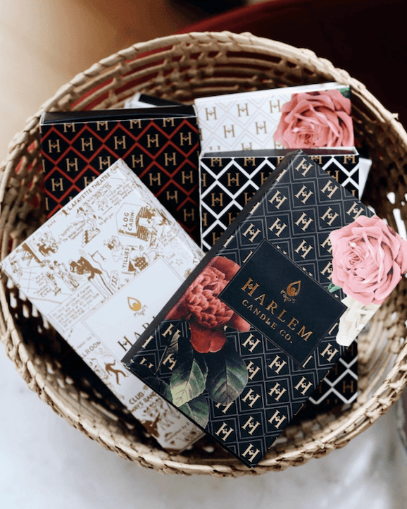 The lifestyle image shows a group of the Harlem Candle Co match boxes displayed in a decorative fashion.